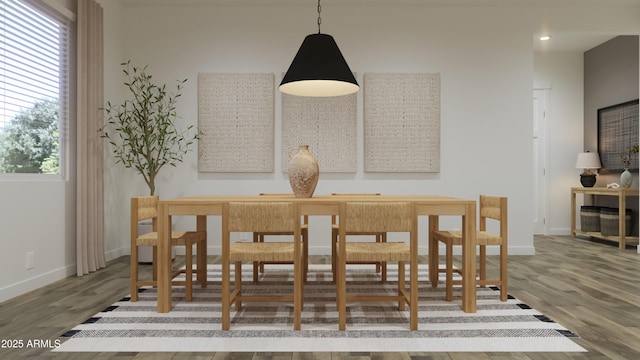 dining area with baseboards, wood finished floors, and recessed lighting