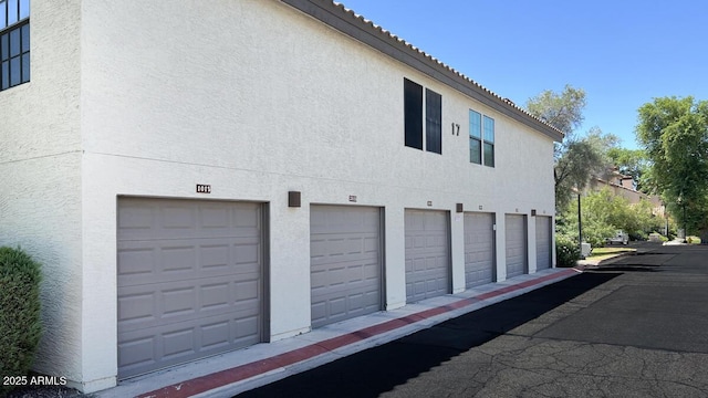 2333 E Southern Ave Unit 1015, Tempe, AZ 85282 - view of property exterior featuring stucco siding, a tiled roof, and a garage