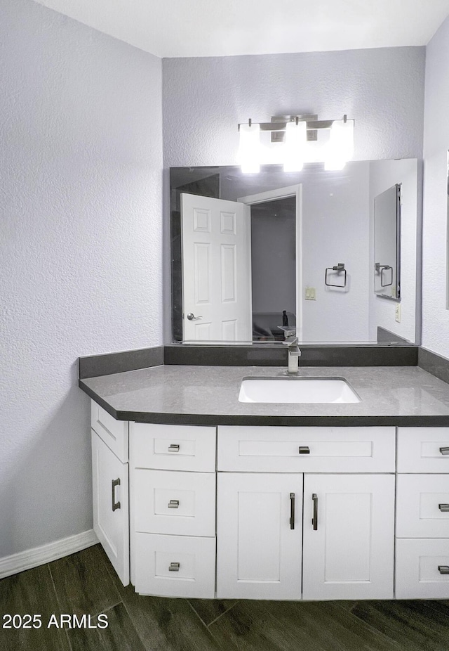 2333 E Southern Ave Unit 1015, Tempe, AZ 85282 - bathroom with vanity, wood finished floors, and a textured wall