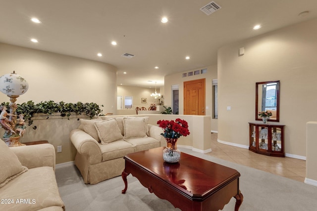 living room with tile flooring and an inviting chandelier