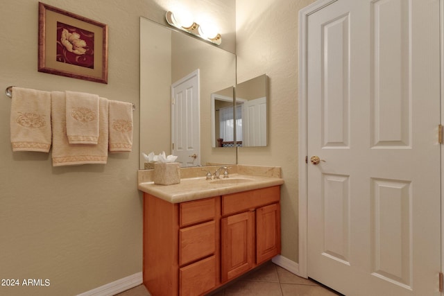 bathroom with vanity with extensive cabinet space and tile floors