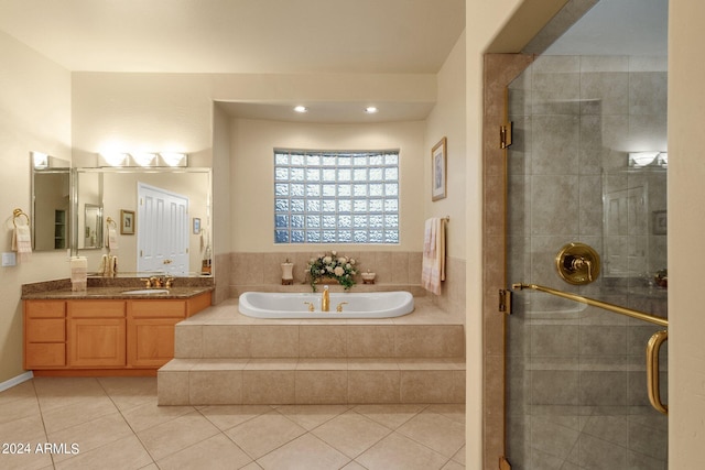 bathroom with tile flooring, shower with separate bathtub, and oversized vanity