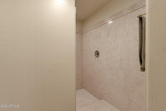 bathroom with tiled shower