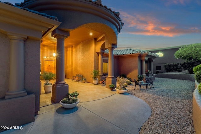 view of patio terrace at dusk