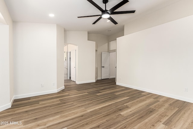 1710 S Aaron, Mesa, AZ 85209 - unfurnished room with arched walkways, wood finished floors, a ceiling fan, baseboards, and lofted ceiling