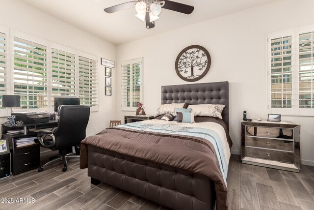 bedroom with baseboards, a ceiling fan, and wood finished floors