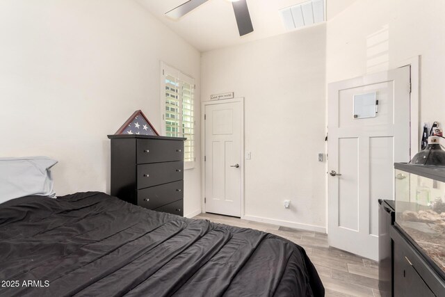 bedroom featuring ceiling fan, visible vents, and light wood finished floors