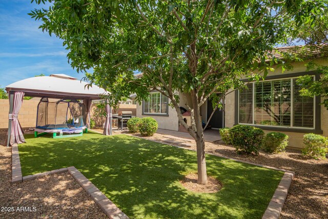view of yard featuring a gazebo, fence, and a patio