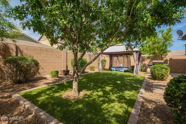 view of yard featuring a gazebo and a fenced backyard
