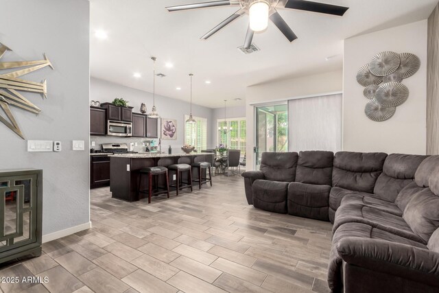 living room featuring ceiling fan, recessed lighting, light wood-style flooring, and visible vents