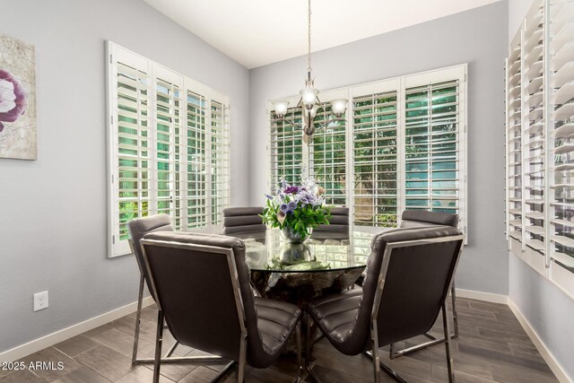 dining room with an inviting chandelier, baseboards, and wood finished floors