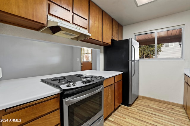 kitchen featuring appliances with stainless steel finishes, a healthy amount of sunlight, and light wood-type flooring