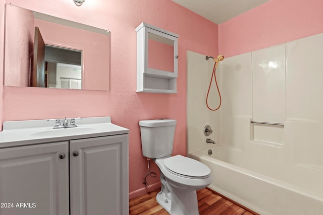 full bathroom with vanity, hardwood / wood-style flooring, toilet, and bathing tub / shower combination