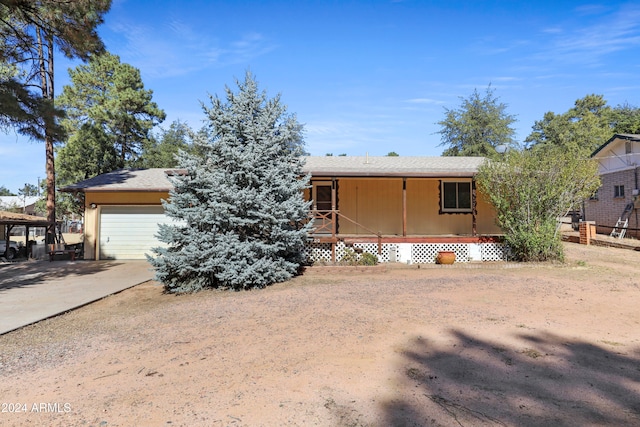 view of front of home featuring covered porch and a garage