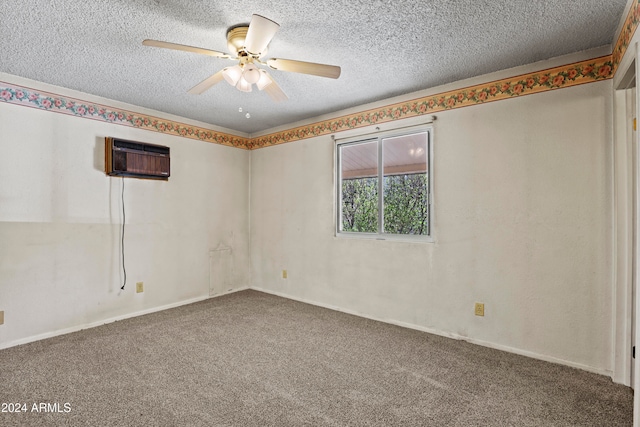 spare room featuring carpet flooring, a wall unit AC, a textured ceiling, and ceiling fan