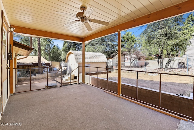 view of patio / terrace with a storage shed and ceiling fan