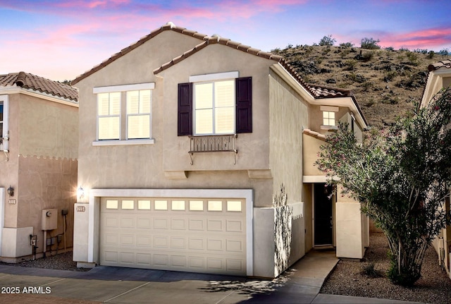 215 W Mountain Sage Dr, Phoenix, AZ 85045 - view of front facade featuring a garage, stucco siding, a tile roof, and concrete driveway
