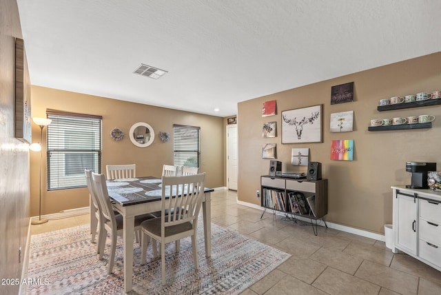 dining area featuring light tile patterned floors