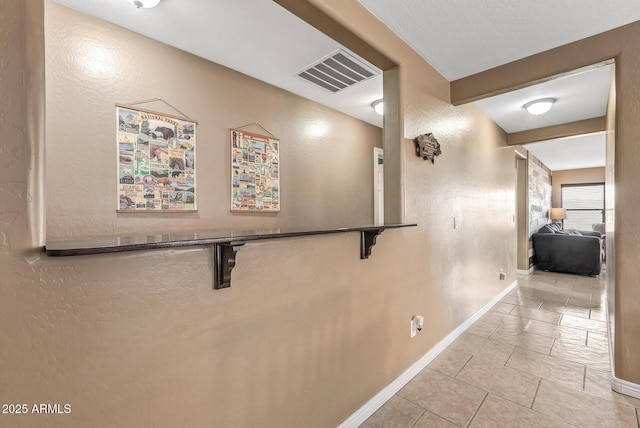 corridor with light tile patterned floors