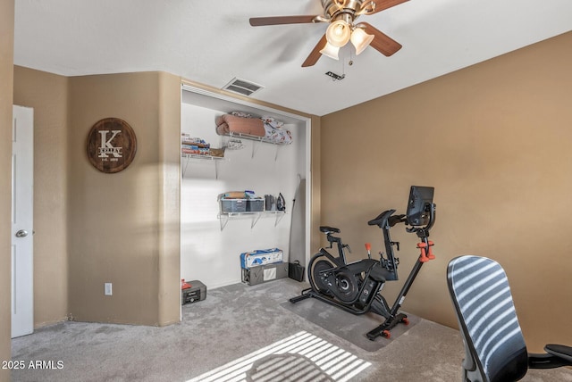 workout area with ceiling fan and carpet flooring