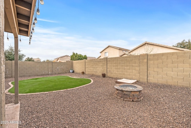 view of yard with an outdoor fire pit