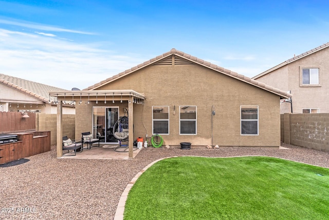 back of house with a patio and a lawn