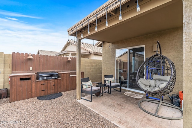 view of patio / terrace featuring a grill and exterior kitchen