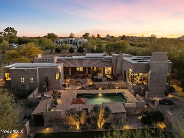 view of back house at dusk