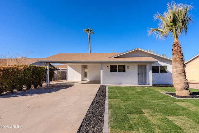 single story home with a front yard and a carport