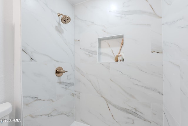 bathroom with tiled shower