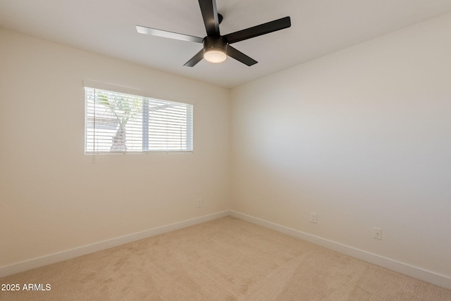 spare room featuring ceiling fan and light colored carpet