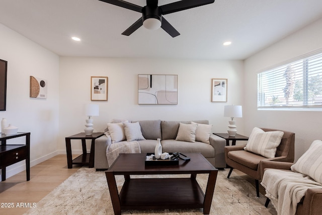 living room with ceiling fan and light wood-type flooring