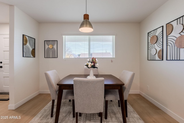 dining space featuring light wood-type flooring