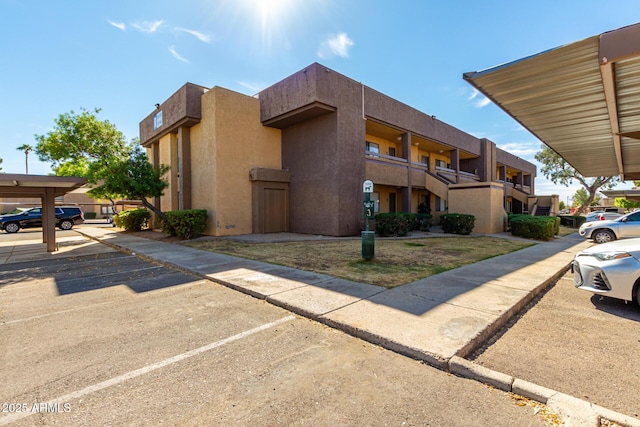 view of property featuring uncovered parking