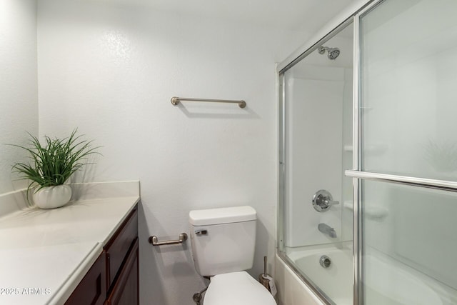bathroom featuring shower / bath combination with glass door, toilet, and vanity