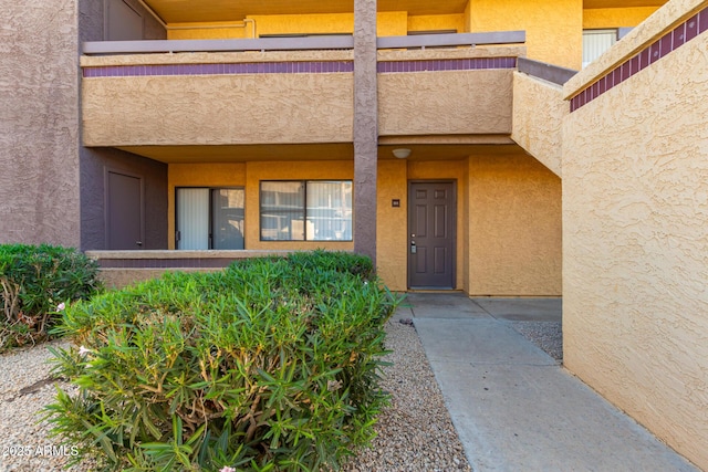 doorway to property with stucco siding