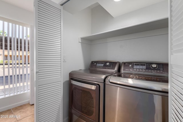 laundry area featuring light tile patterned floors, laundry area, and washing machine and dryer
