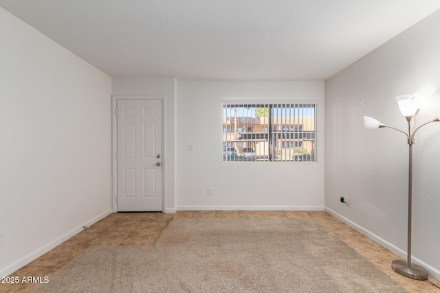 spare room with carpet floors and baseboards