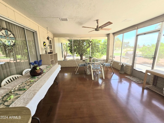 sunroom featuring ceiling fan