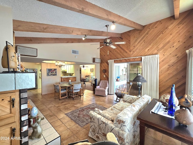 tiled living room with wood walls, a textured ceiling, high vaulted ceiling, ceiling fan, and beam ceiling