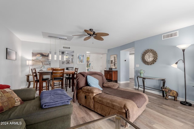 living room featuring ceiling fan and light wood-type flooring