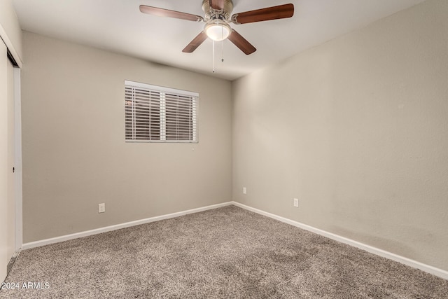 empty room featuring carpet floors and ceiling fan