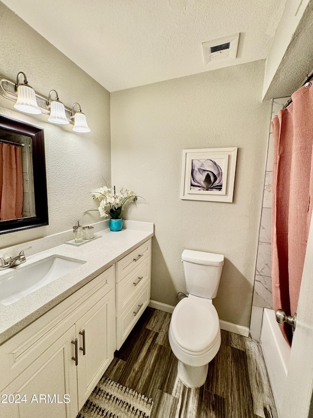 full bathroom featuring toilet, a textured ceiling, wood-type flooring, vanity, and shower / bathtub combination with curtain