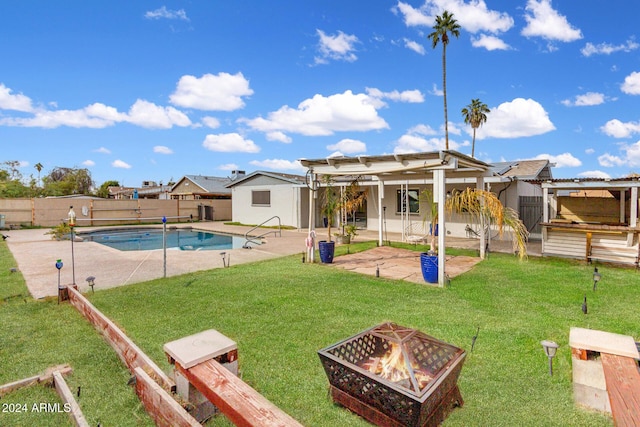 view of swimming pool featuring a fire pit, a lawn, and a patio