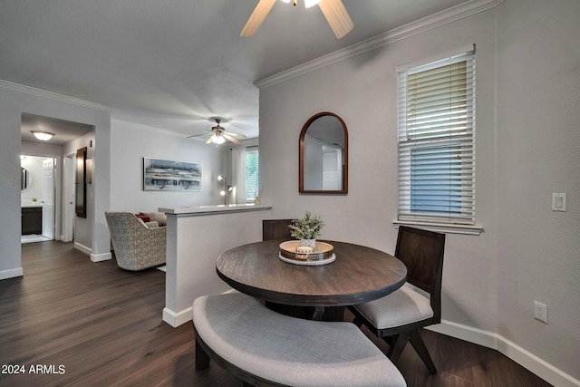 dining space with dark hardwood / wood-style flooring, ornamental molding, and ceiling fan