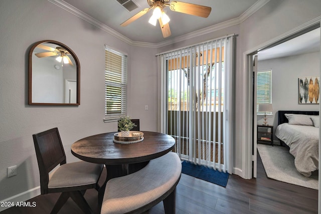 dining space with dark wood-type flooring, ceiling fan, and ornamental molding