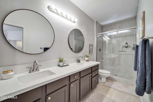 bathroom featuring vanity, toilet, an enclosed shower, and tile patterned flooring