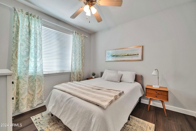 bedroom with dark hardwood / wood-style floors and ceiling fan