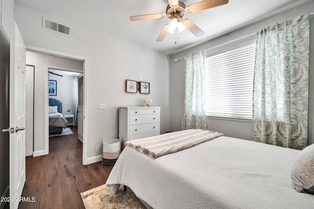 bedroom with ceiling fan and dark hardwood / wood-style flooring