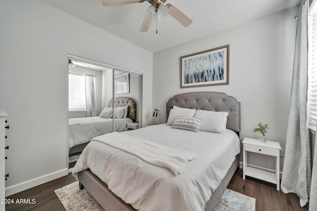 bedroom with dark hardwood / wood-style flooring, a closet, and ceiling fan